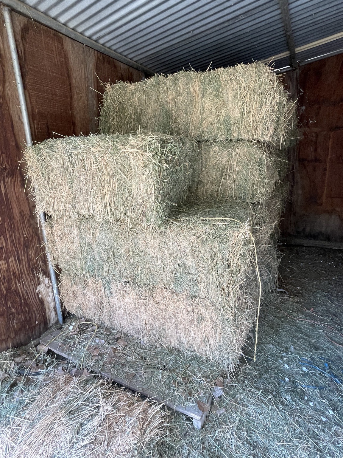 Stacked hay bales in our ranch barn
